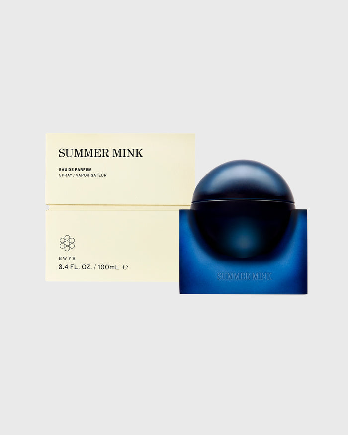 Summer Mink Eau de Parfum 100ml bottle with dark spherical cap and blue base box next to cream-colored packaging.