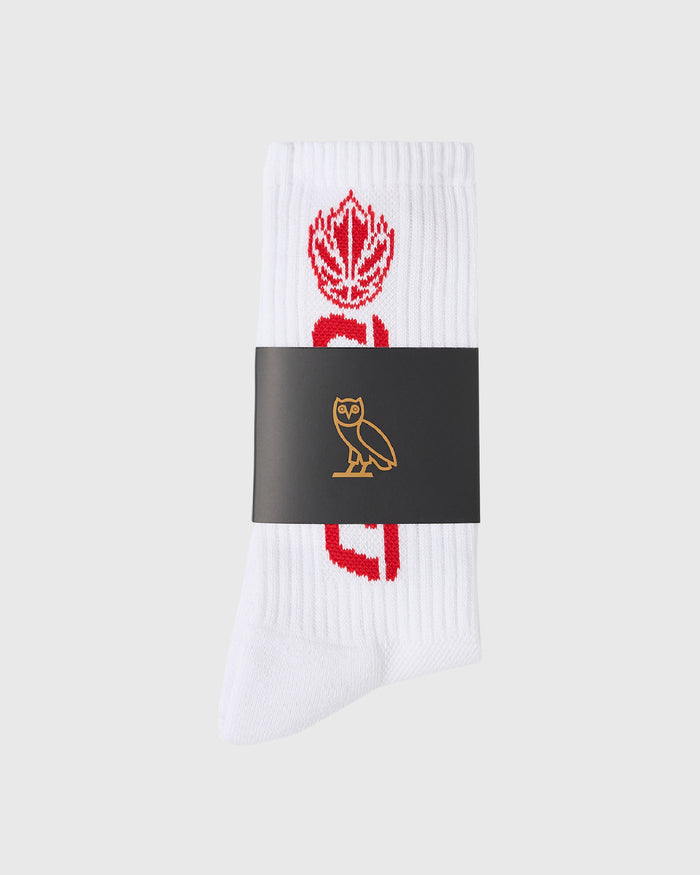 White ribbed sock with red Canada maple leaf and text design on foot.