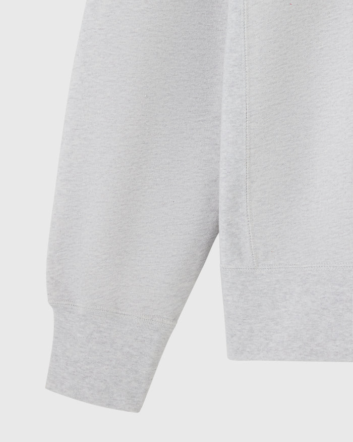 Ash heather grey crewneck sweatshirt showing sleeve and torso detail.