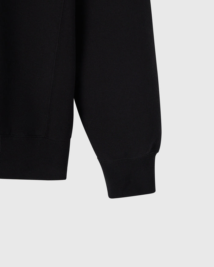 Black crewneck sweatshirt with ribbed cuffs and hem detail.
