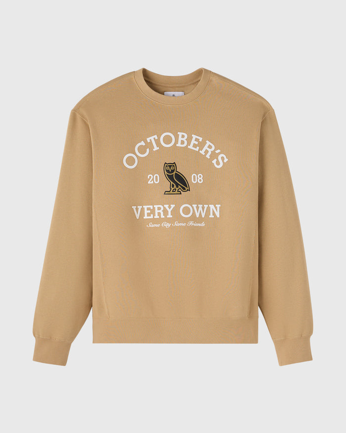 Tan crewneck sweatshirt with white "Octobers Very Own" text, owl graphic, and "2008" below on chest.