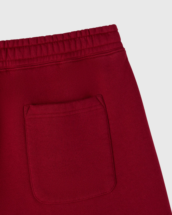 Deep red collegiate shorts with elasticated waistband and front patch pocket.