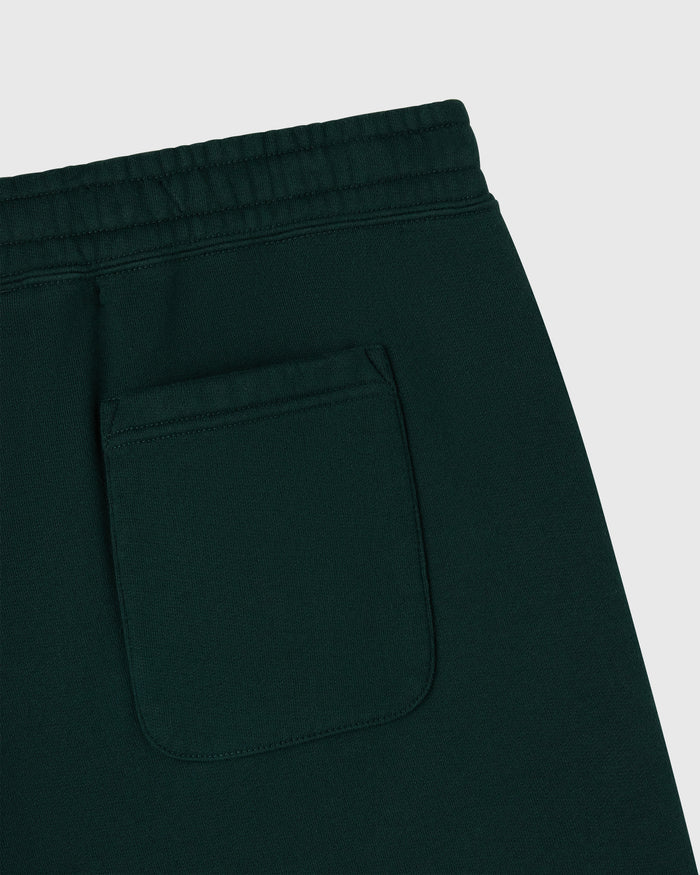 Midnight green sweatpants with elastic waistband and front pocket detail.