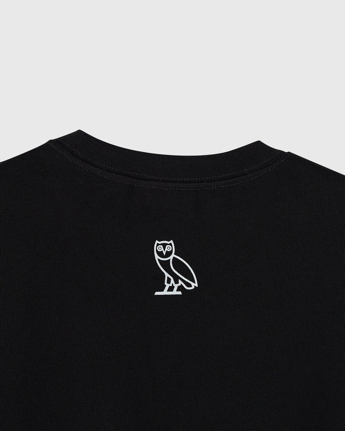 Black heavy jersey t-shirt with white owl graphic on chest and crew neckline.
