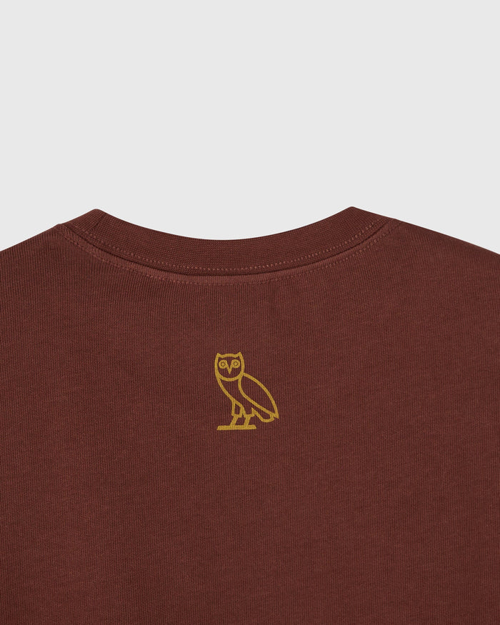 Hickory-colored heavy jersey t-shirt with gold owl embroidery on chest and crew neckline.