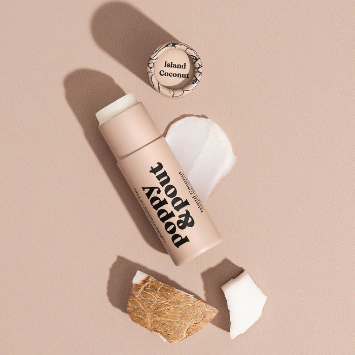 Island Coconut lip balm tube with cap open and white balm residue
