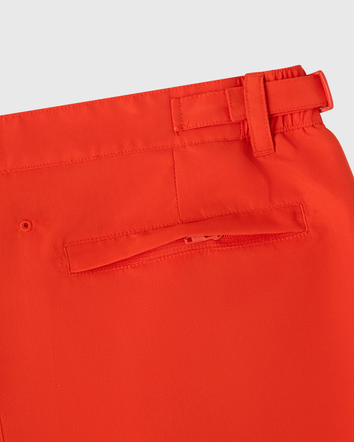 Signal orange swim short with elasticated waistband, side zip pocket, and drawstring closure detail.
