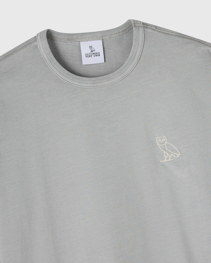 Gray long-sleeve crewneck tee with small owl embroidery on chest and October's Very Own brand label.