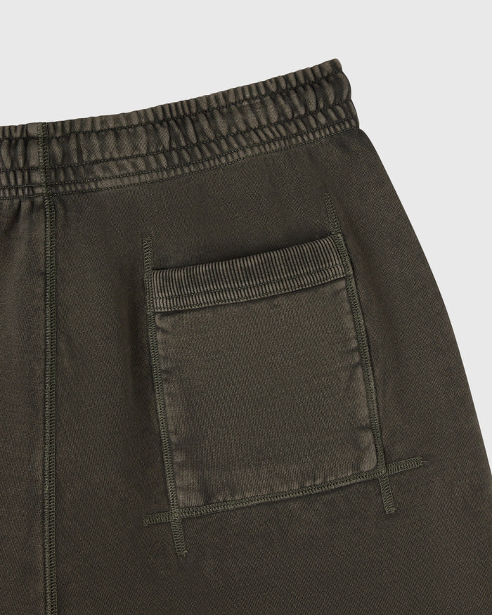 Deep olive sweatshorts with elasticated waistband and front patch pockets with visible stitching detail.