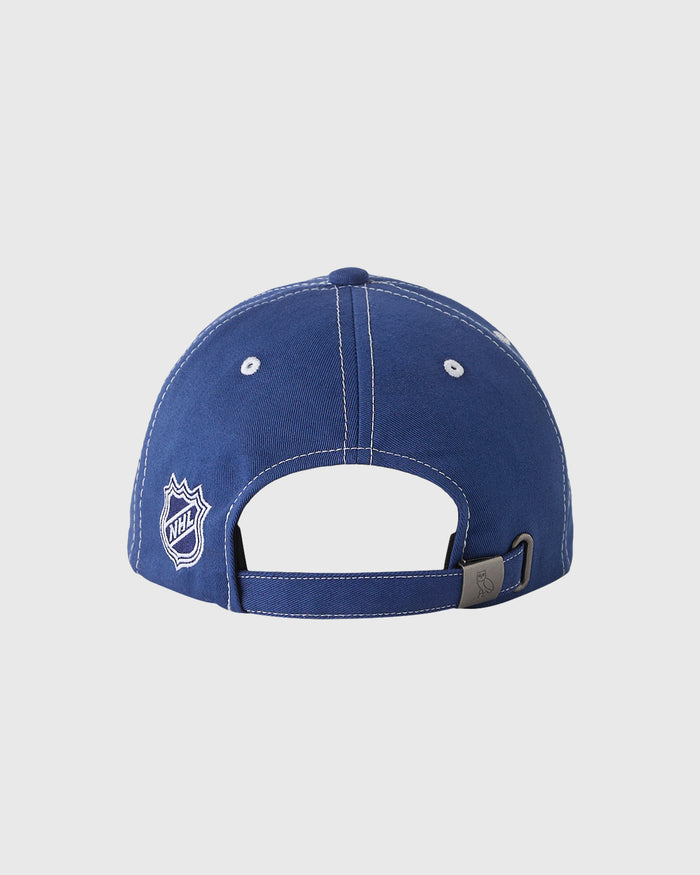Blue baseball cap with NHL logo on left side, white eyelets, and adjustable back strap.