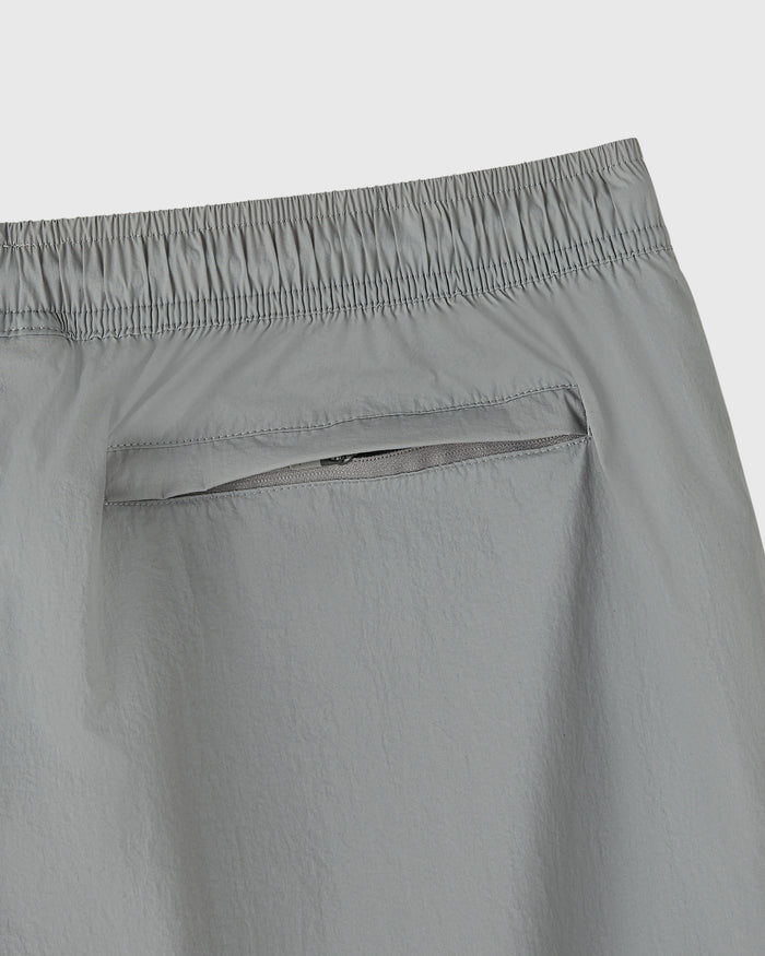 Cool grey nylon track short with elastic waistband and zippered back pocket.
