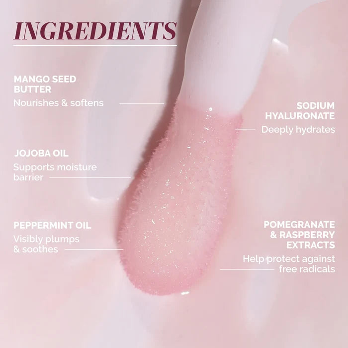 A close-up of LONDONTOWN’s Quench Glow Buttery Lip Oil - Au Naturale on an applicator, featuring mango seed butter, jojoba oil, peppermint oil, sodium hyaluronate, and fruit extracts for plush shine and deep hydration.
