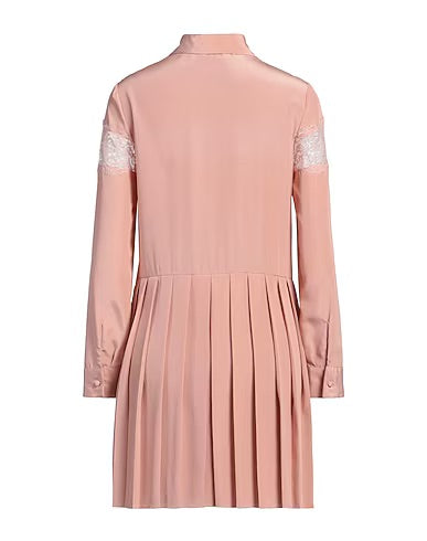 Red Valentino blush shirt dress hanging on a hanger, showcasing its soft fabric and stylish design.