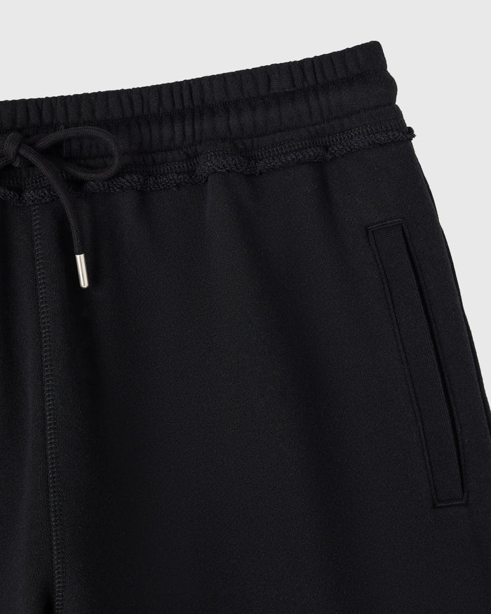Black sweatshort with ribbed waistband, drawstring, and side pocket detail.