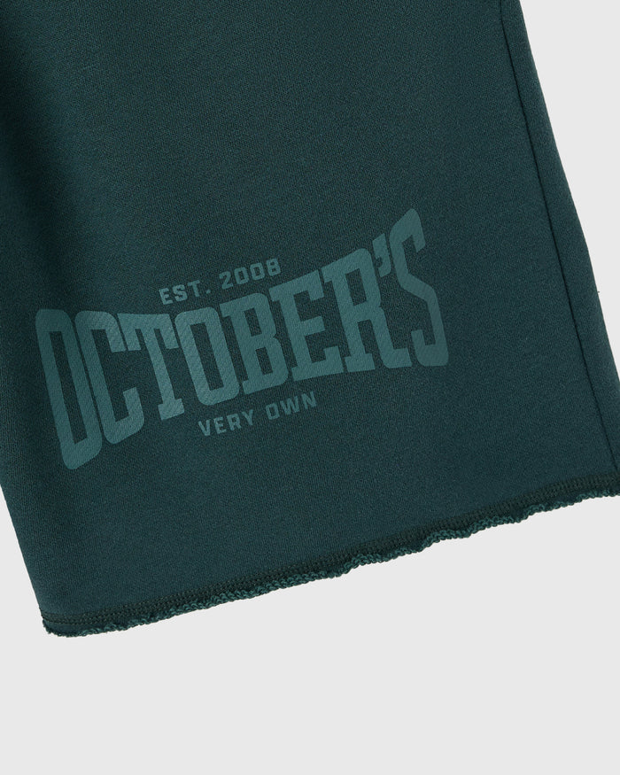 Midnight green sweatshort with tonal graphic text reading "Est. 2008 Damblers Very Own" on front.