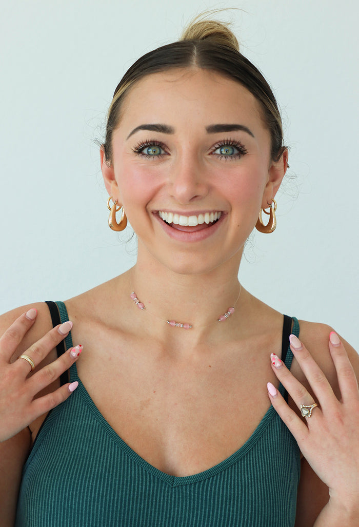 girl wearing pink beaded choker necklace