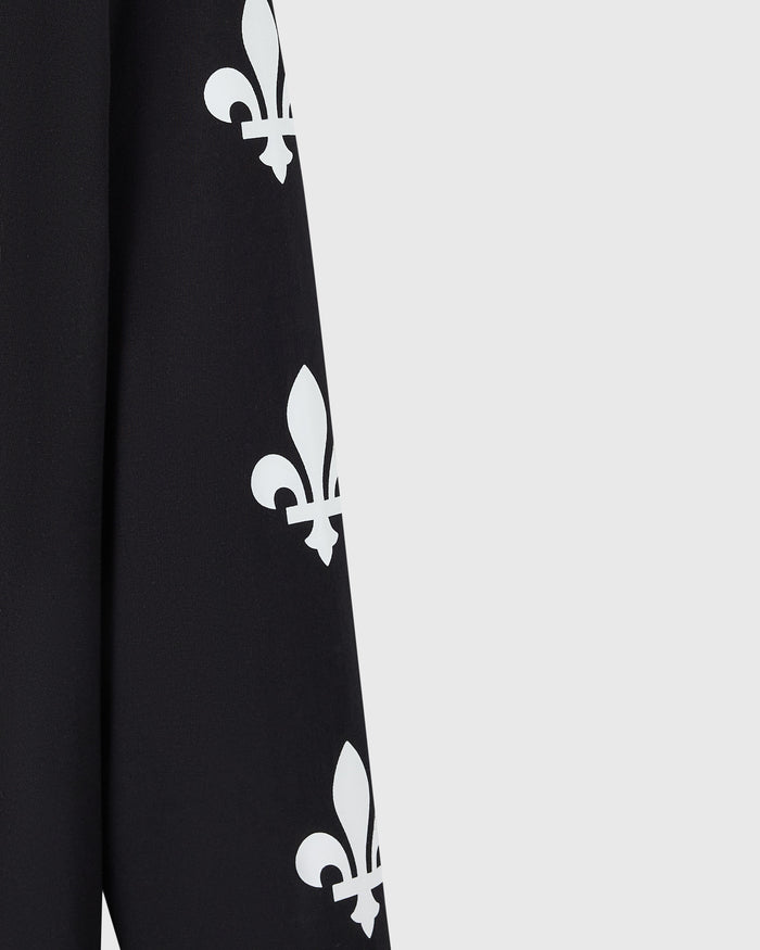 Close up of black long-sleeve tee with white fleur-de-lis symbols printed vertically down the front.