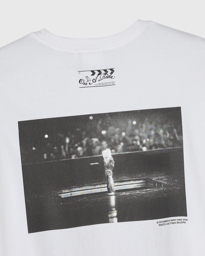 White crewneck tee with black and white photograph graphic and text print on chest and front.