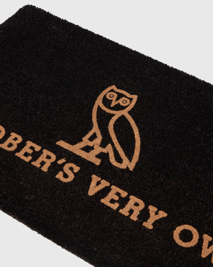 Black welcome mat with tan owl illustration and "BERRY VERY OWL" text.