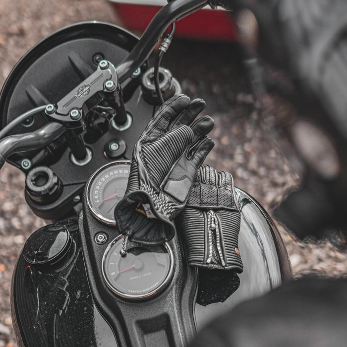 Goldtop raptor women's gloves black on motorcycle tank