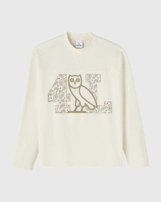 Cream long-sleeve tee with tan owl graphic in center chest surrounded by paisley pattern details.