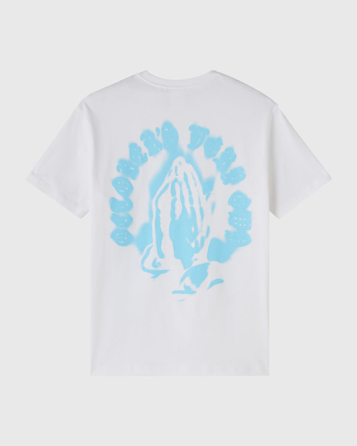 White t-shirt with light blue airbrush graphic of praying hands surrounded by circular text design on front.