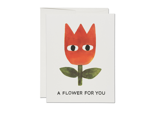 Friendship card with red cartoon flower face and "A FLOWER FOR YOU" text
