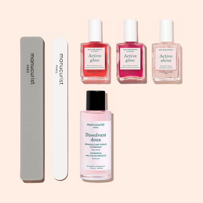 The Manucurist Active Manicure Kit features two nail files, three bottles of nail treatment polish, and a bottle of nail polish remover—each item neatly arranged on a light beige background, making it the perfect addition to any manicure kit.