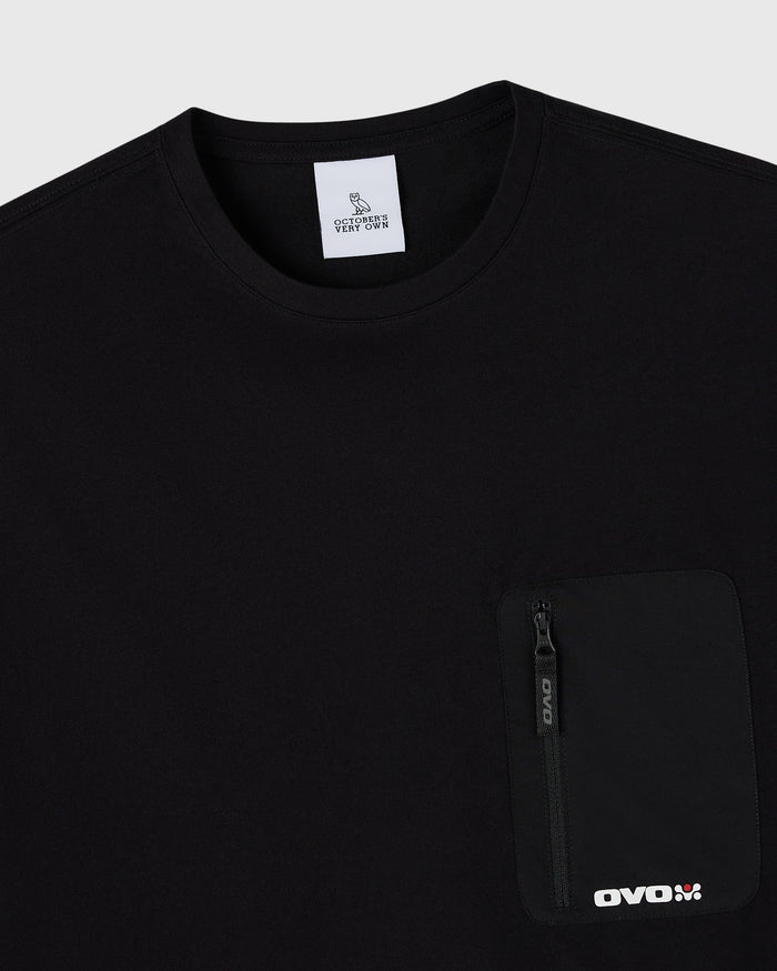 Black crew neck t-shirt with chest pocket featuring a zipper and "OVOX" branding.