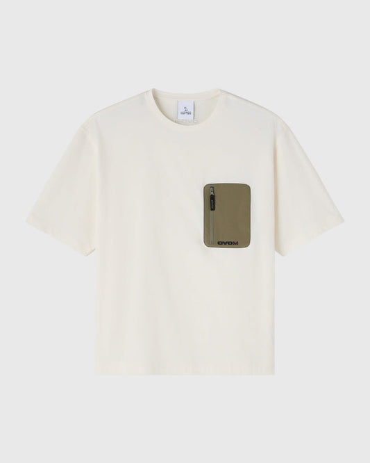 Cream short-sleeve tee with olive green pocket featuring a zippered compartment on chest.