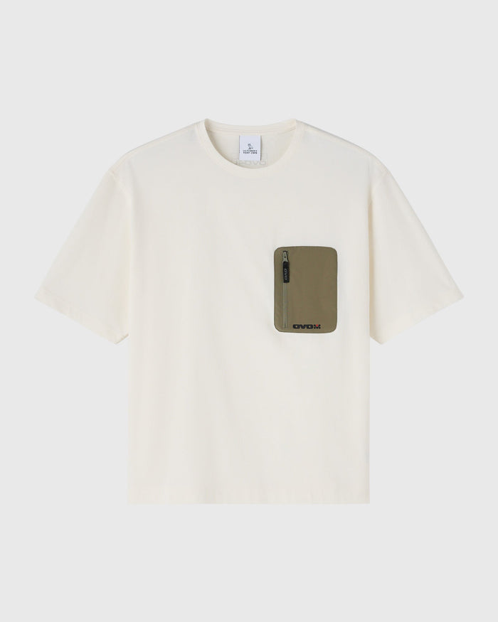 Cream short-sleeve tee with olive green pocket featuring a zippered compartment on chest.
