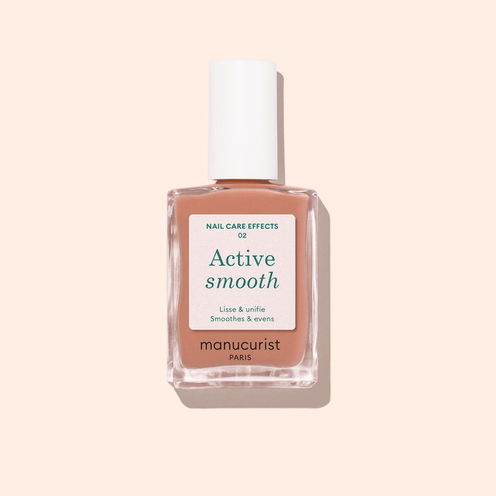 A bottle of Manucurist Active™ Smooth 02 nail care polish with a white cap, displayed against a pale peach background. The white label with green and black text emphasizes this advanced CC Polish as an ideal treatment for healthier-looking nails.