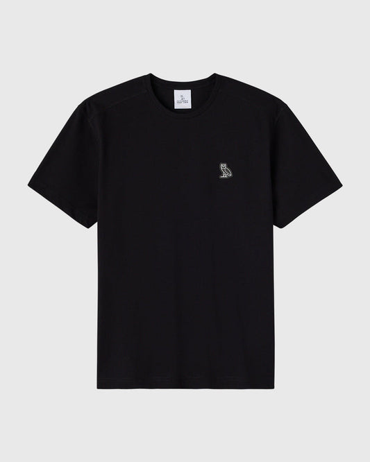 Black crew neck t-shirt with small owl emblem on chest.
