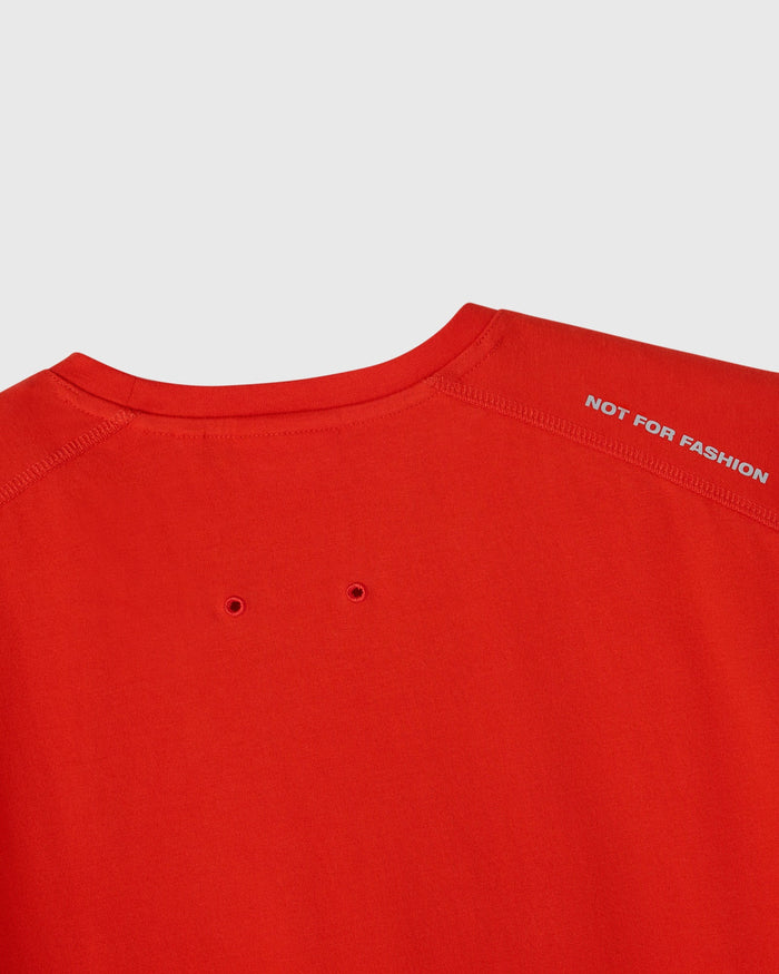 Signal orange t-shirt with crew neckline and small ventilation holes on the chest.