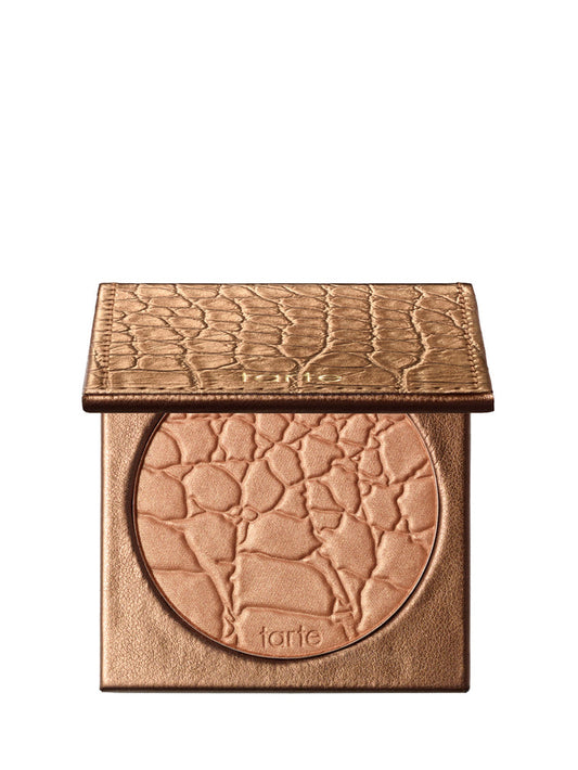 Bronze-colored makeup compact with 'tarte' branding on a white background