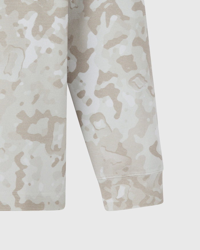 Long-sleeve tee with beige and white desert camouflage pattern and textured waffle knit fabric.