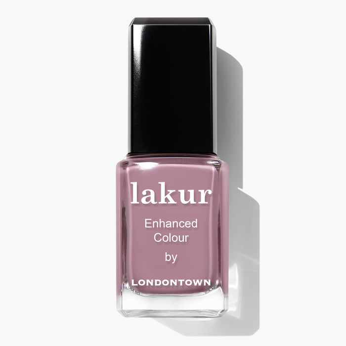 A bottle of LONDONTOWN Bell Flower lakur nail polish in a romantic dusty pink color with a black cap. The label reads "Enhanced Colour by.