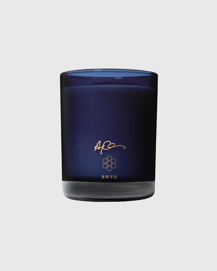 Dark blue glass candle jar with gold logo and "BWFH" text on the label.