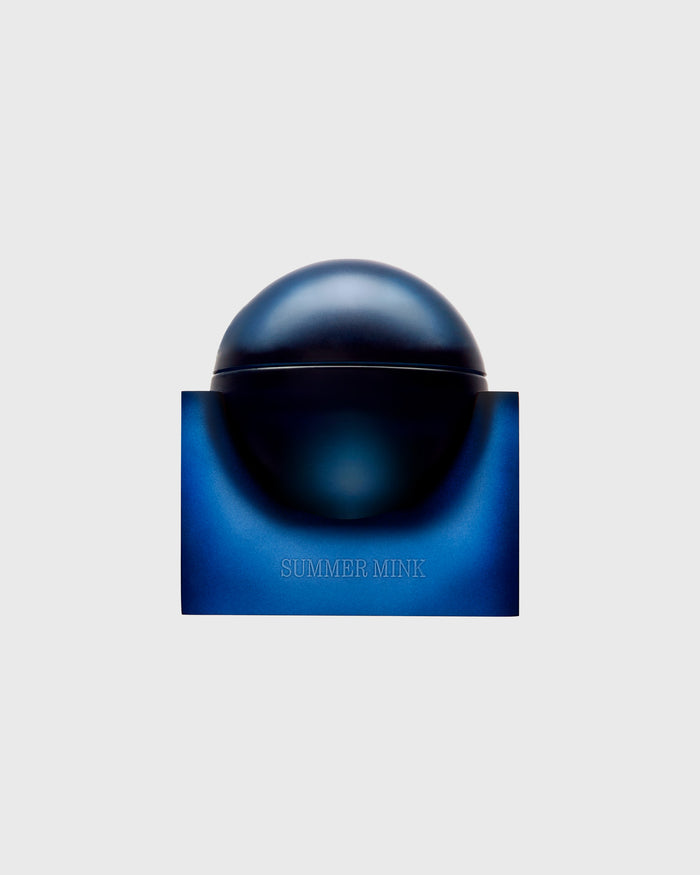 Dark spherical perfume bottle with blue base box labeled "Summer Mink."