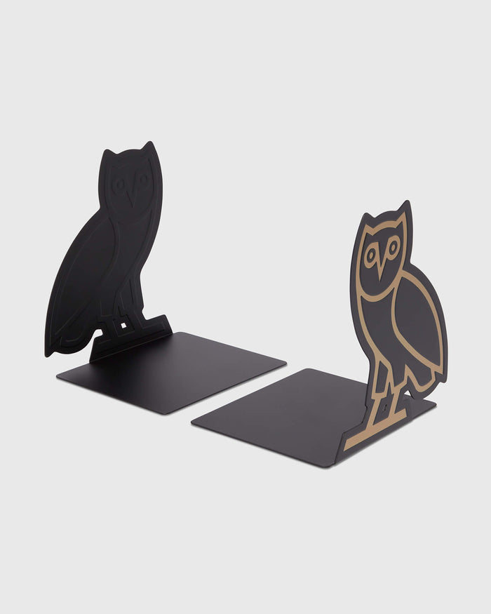 Pair of owl-shaped bookends with black bases and black and gold metal silhouettes.