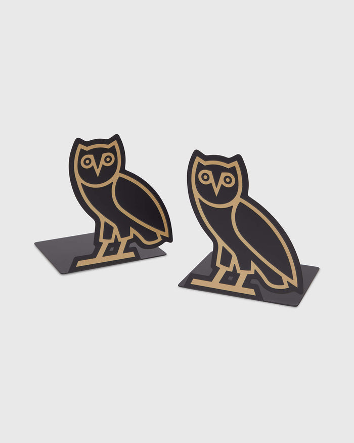 Pair of black bookends with gold owl designs and weighted bases.