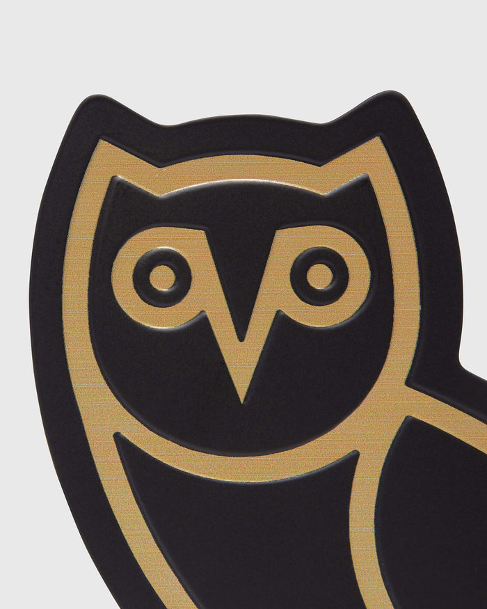 Pair of black bookends with gold owl design featuring circular eyes and geometric details.