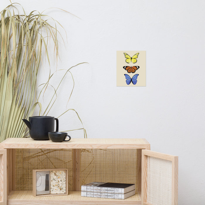 three butterflies with yellow, orange, and then blue in a vertical line
