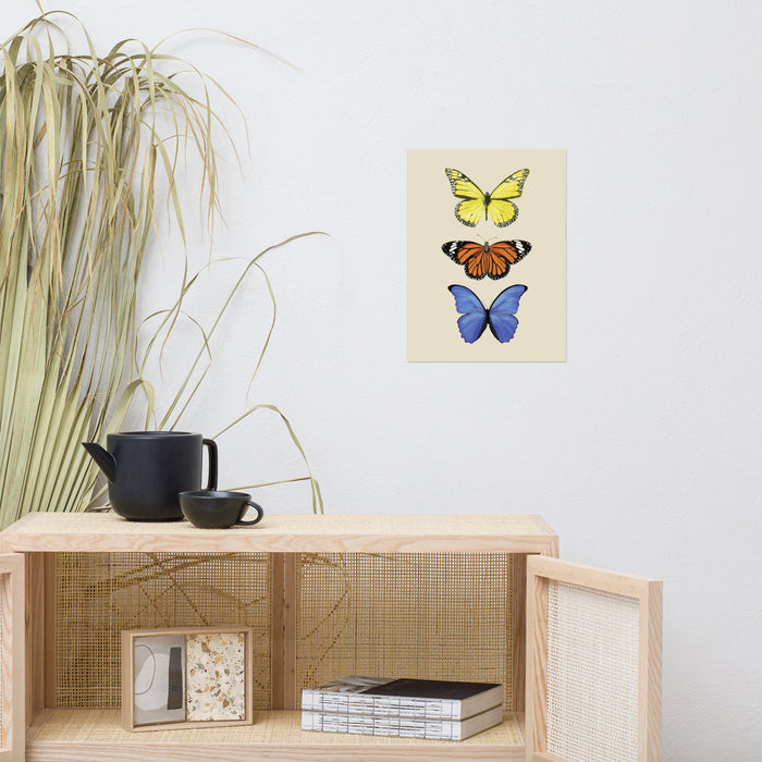 three butterflies with yellow, orange, and then blue in a vertical line