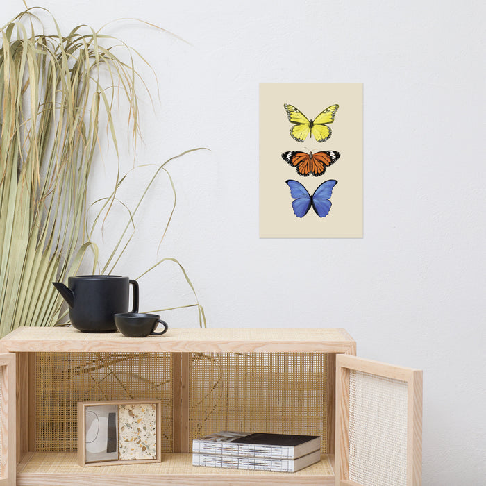three butterflies with yellow, orange, and then blue in a vertical line