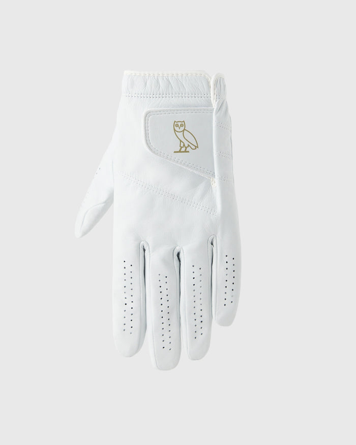White golf glove with gold owl logo on back and perforated grip pattern on palm and fingers.