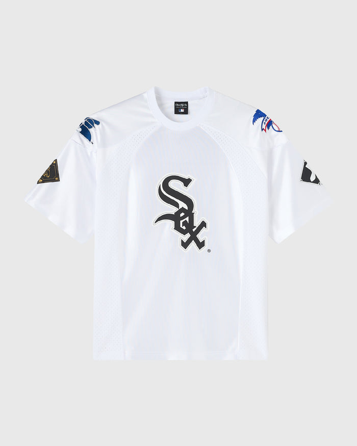 A white short-sleeve baseball jersey with a large black Chicago White Sox 'SOX' logo on the chest, featuring blue and black sleeve patches, displayed on a light gray background.