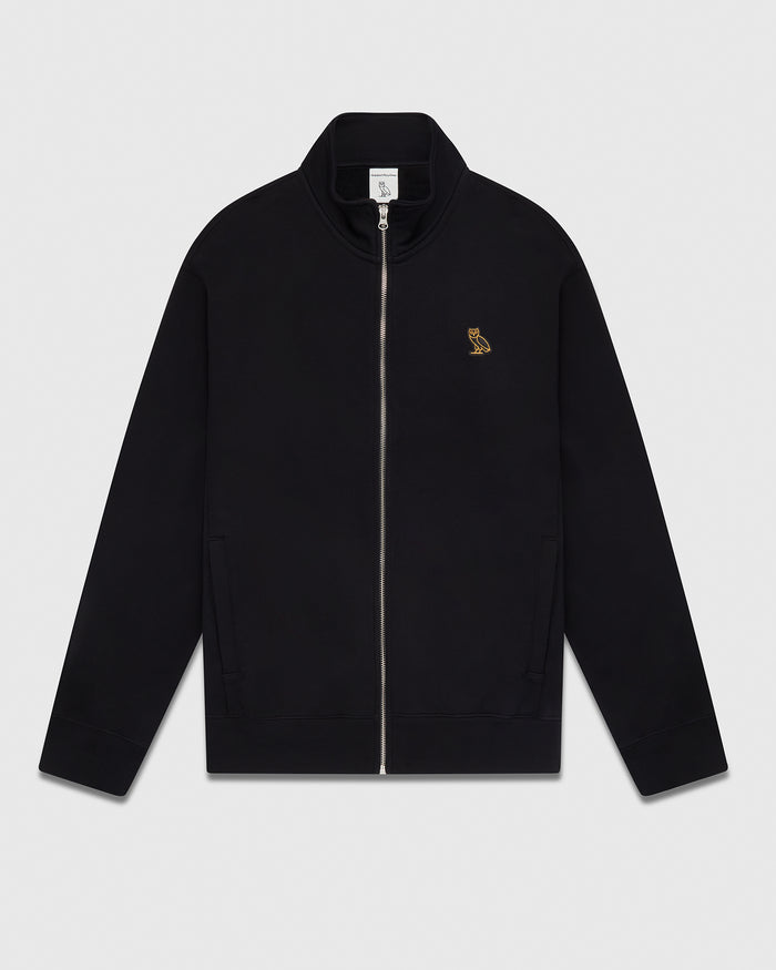 Black full-zip track jacket with small gold owl embroidered on chest and front pockets.