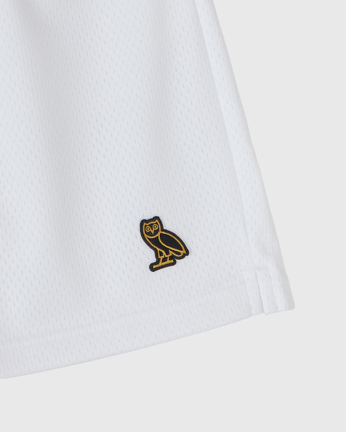 White mesh shorts with small black and gold owl embroidery detail on leg.