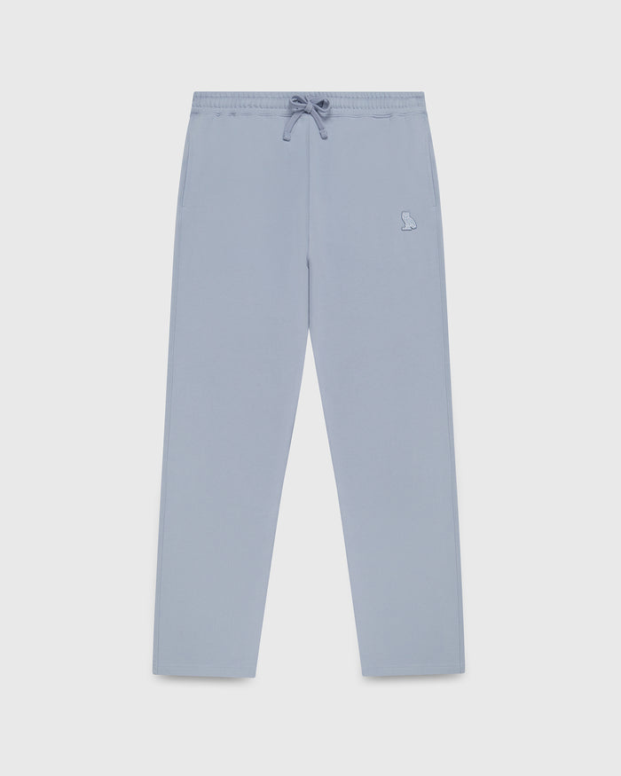 Light blue sweatpant with drawstring waist, small embroidered logo, and open straight hem.